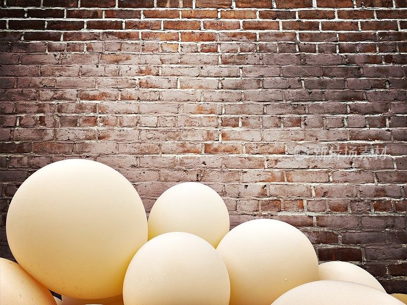 Brown and Blue Balloons against a Brick Wall